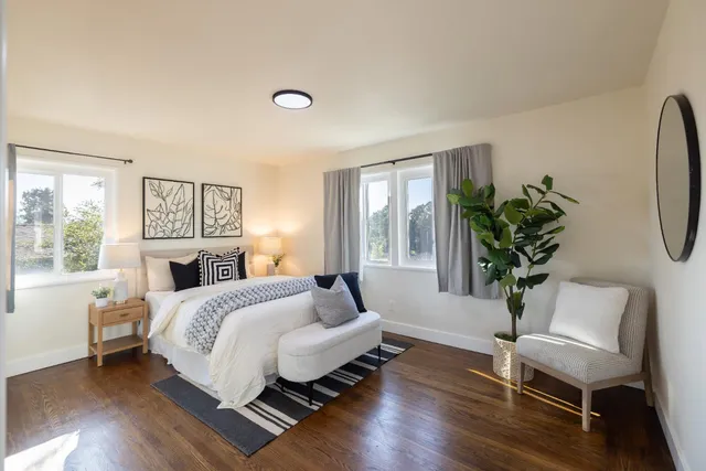 a bed room with a bed and a chair