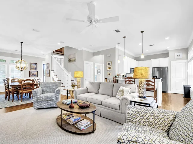 a living room with furniture ceiling fan and a rug