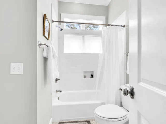 a bathroom with a toilet bathtub and shower