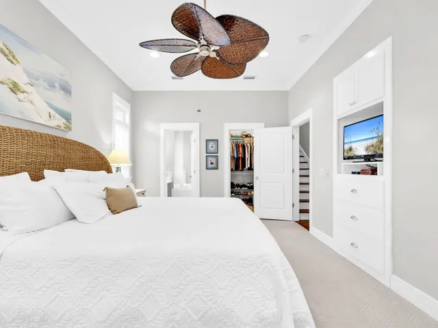 a bedroom with a large bed and a chandelier