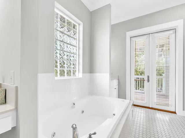 a bathroom with bathtub a window and a shower