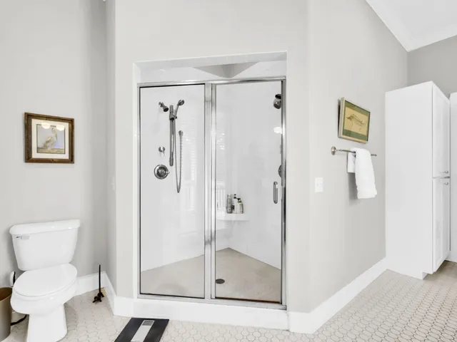 a bathroom with a toilet and a shower