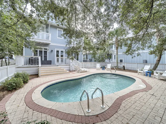 a view of a house with swimming pool and sitting area