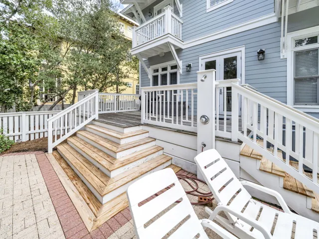 a view of a house with wooden deck