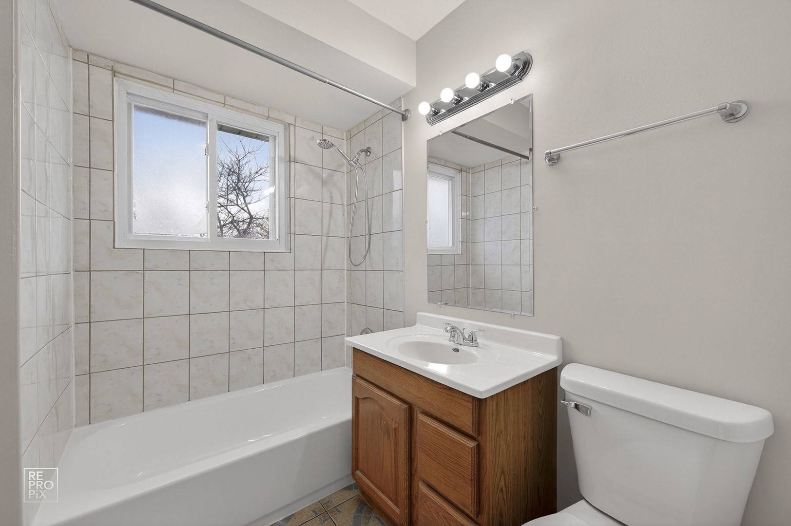 502 East Memorial Road Bensenville, IL 60106 - Photo 13 of 20 a bathroom with a sink toilet and shower