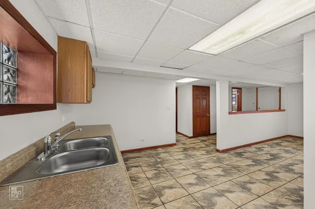 a room with a sink and cabinets