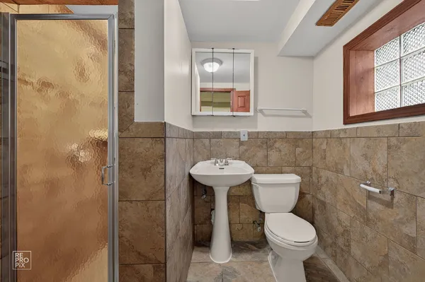 a bathroom with a sink a toilet and a mirror