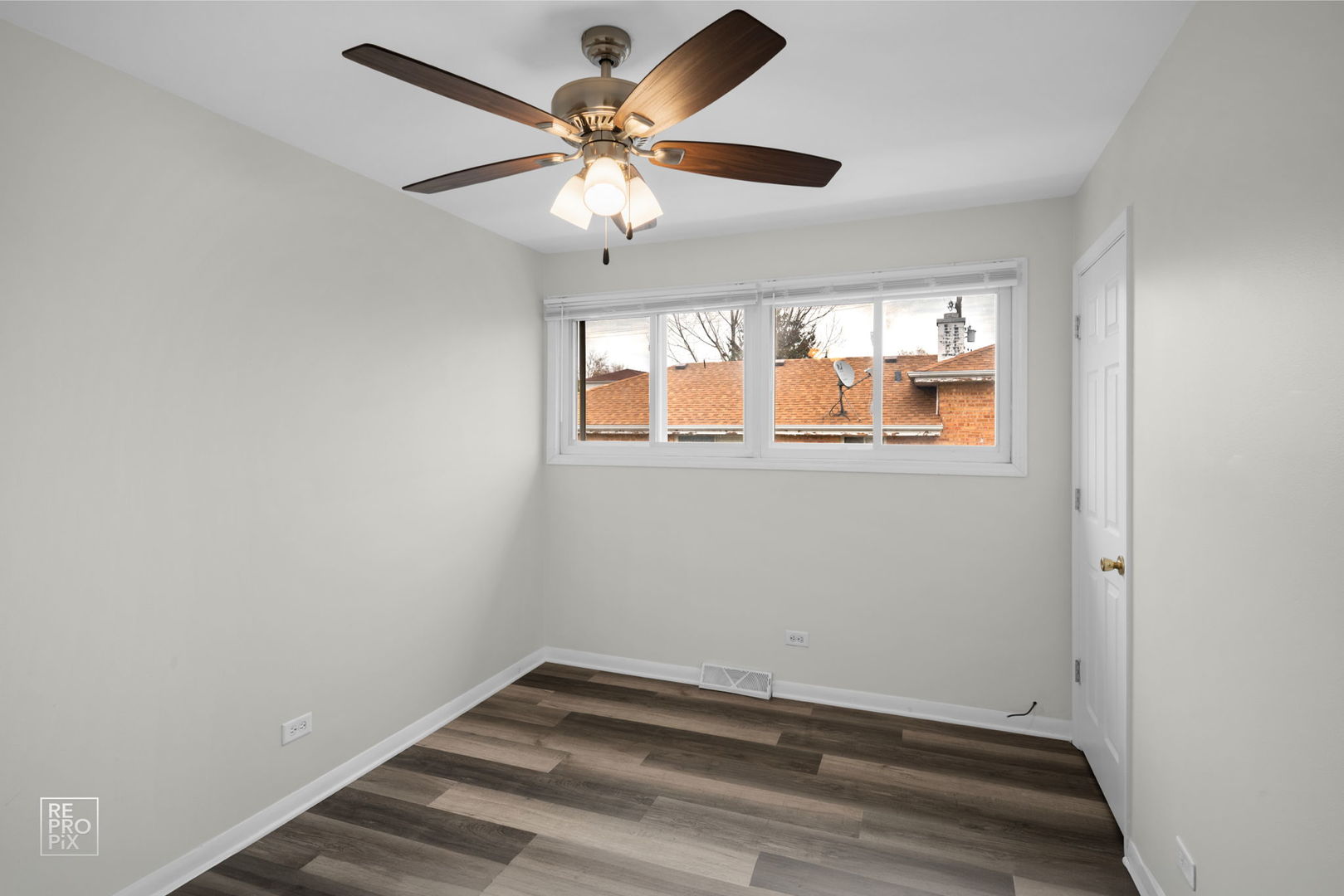 502 East Memorial Road Bensenville, IL 60106 - Photo 6 of 20 an empty room with windows and fan