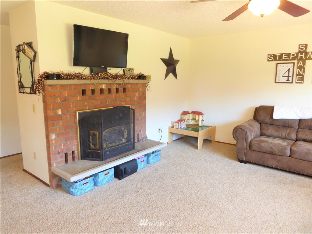 17135 Sargent Road Southwest Rochester, WA 98579 - Photo 14 of 34 a living room with furniture and a fireplace
