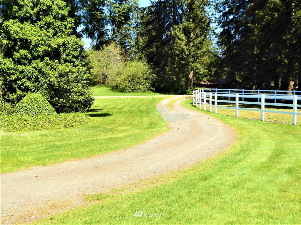 17135 Sargent Road Southwest Rochester, WA 98579 - Photo 29 of 34 a view of a swimming pool with an outdoor space and seating area