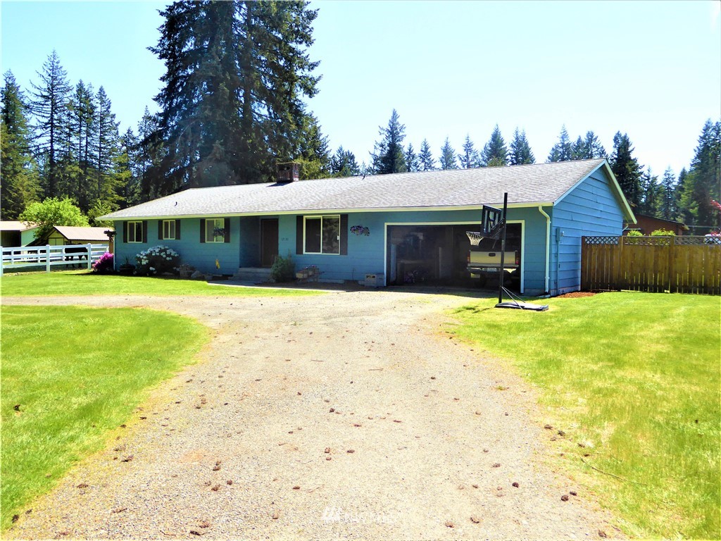 17135 Sargent Road Southwest Rochester, WA 98579 - Photo 30 of 34 a view of a house with a yard and garage