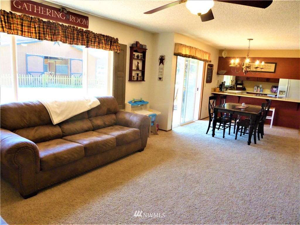 17135 Sargent Road Southwest Rochester, WA 98579 - Photo 9 of 34 a living room with furniture a ceiling fan and a window
