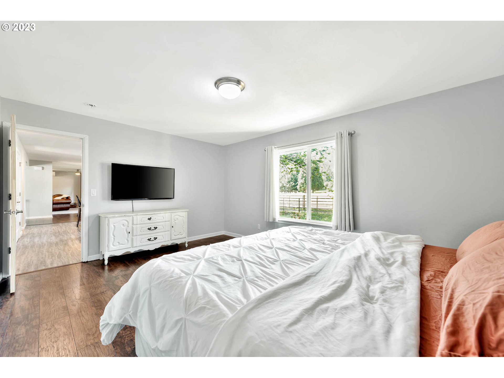 88750 Potter Lane Springfield, OR 97478 - Photo 17 of 43 a bedroom with a bed a window and a flat screen tv