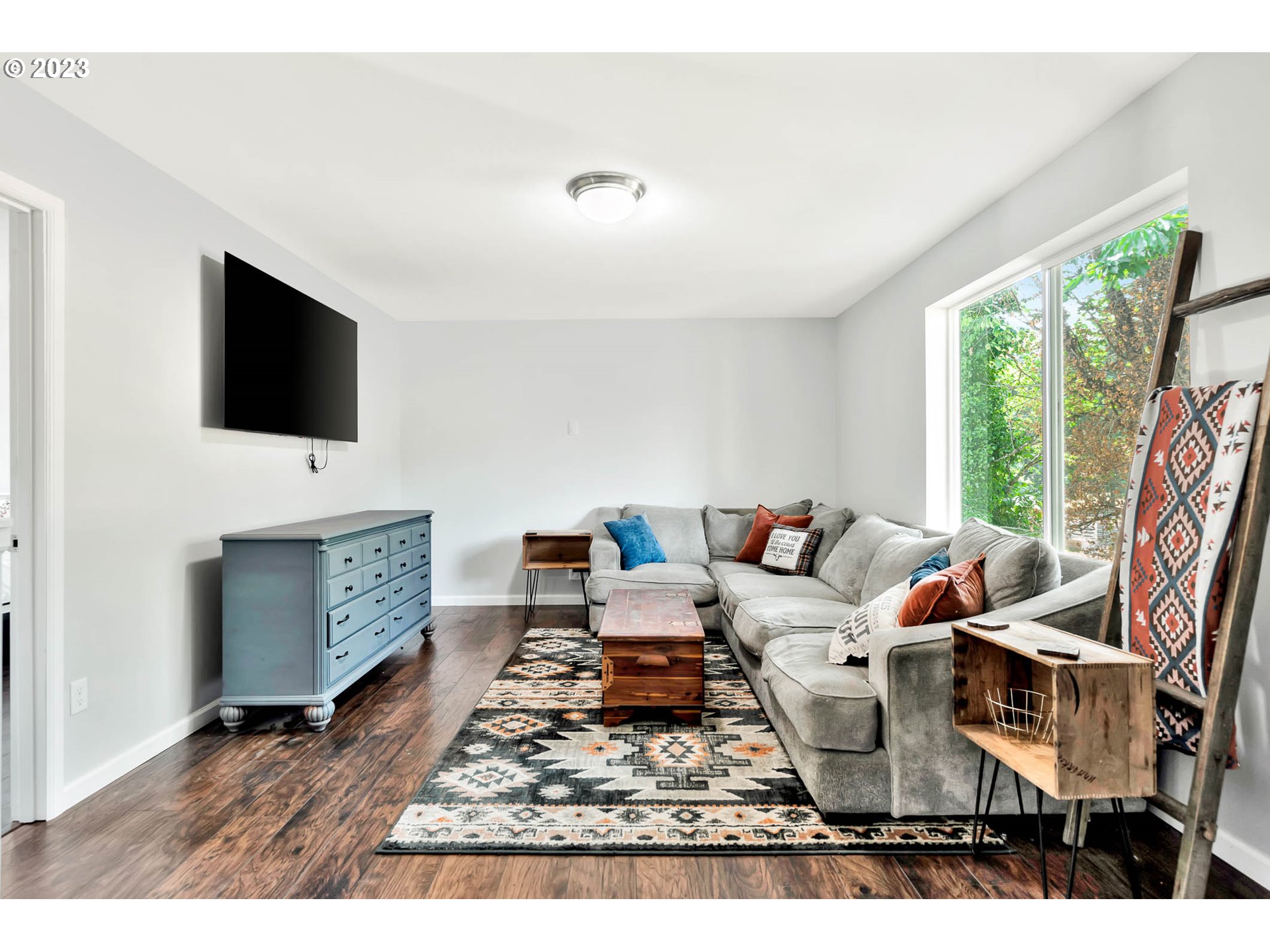 88750 Potter Lane Springfield, OR 97478 - Photo 18 of 43 a living room with furniture a flat screen tv and a floor to ceiling window