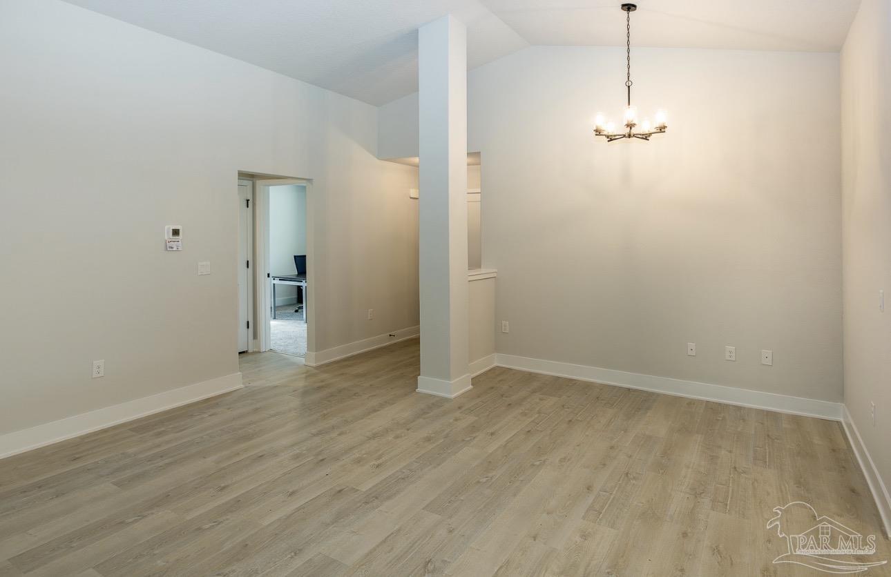 7657 Small Pnes Street Milton, FL 32583 - Photo 8 of 26 an empty room with wooden floor and windows