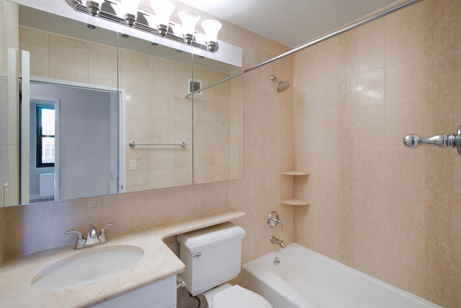 155 East 31st Street, Unit W8F Manhattan, NY 10016 - Photo 4 of 10 a bathroom with a sink a toilet and shower