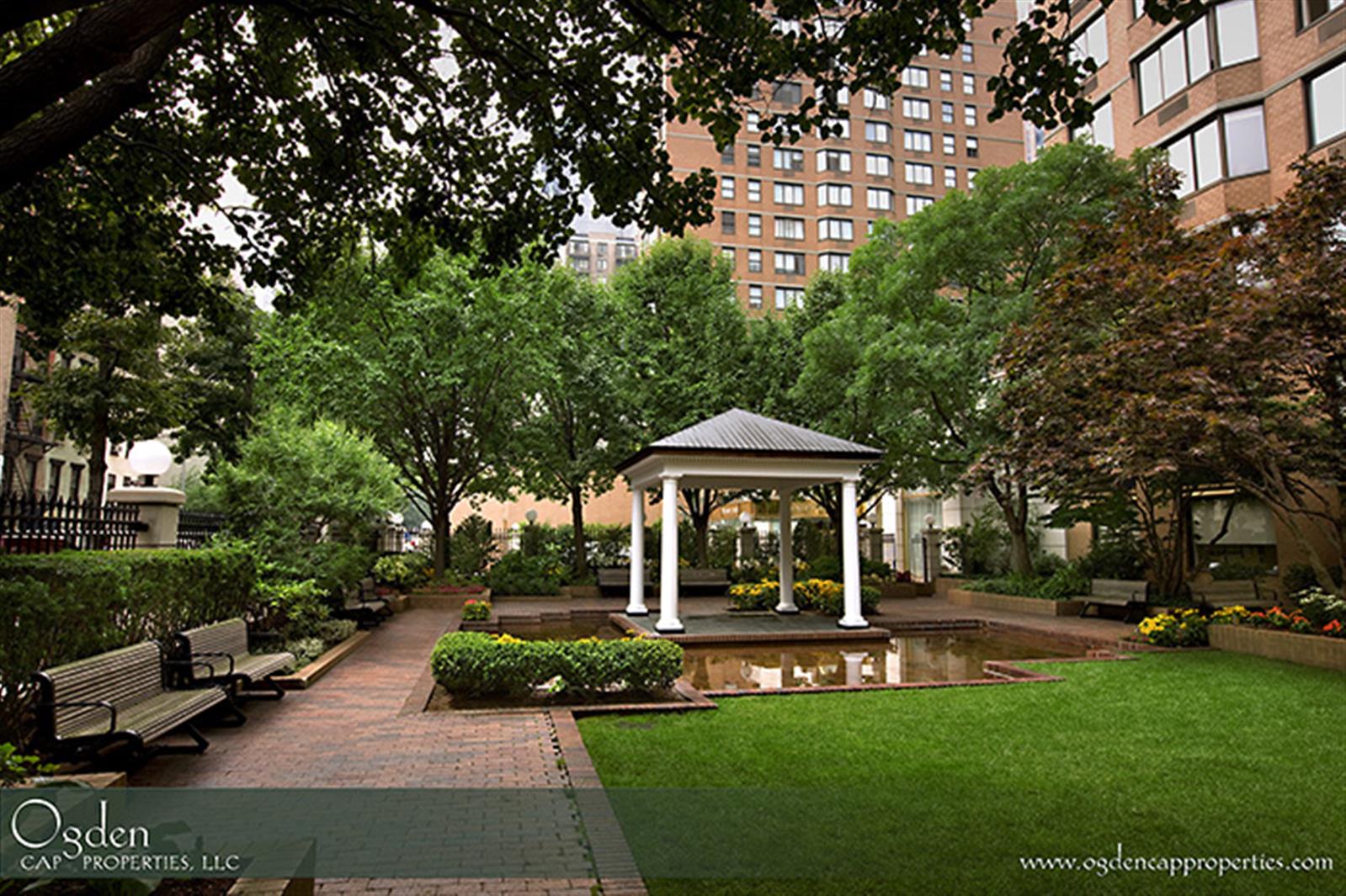 155 East 31st Street, Unit W8F Manhattan, NY 10016 - Photo 6 of 10 a view of a patio with table and chairs under an umbrella
