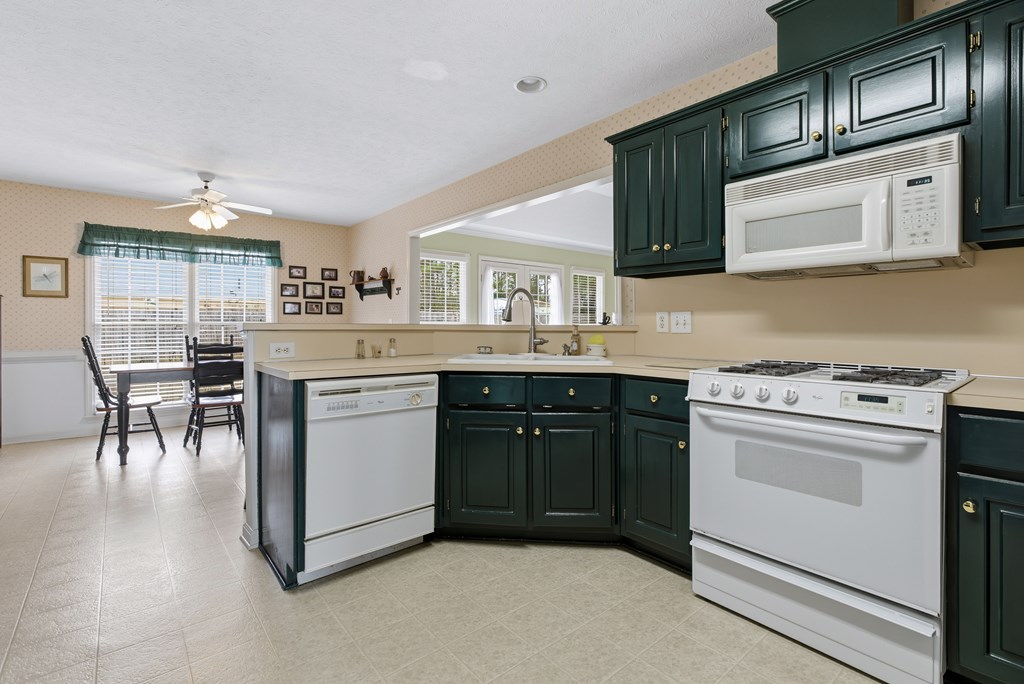 4827 Cedar Ridge Drive Columbus, GA 31909 - Photo 12 of 33 a kitchen with stainless steel appliances granite countertop a stove and a microwave