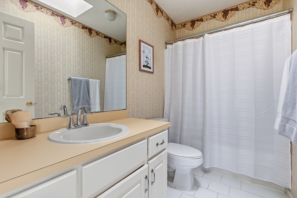 4827 Cedar Ridge Drive Columbus, GA 31909 - Photo 24 of 33 a bathroom with a sink a toilet and shower curtain