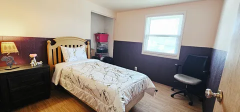 a bedroom with a bed and a window