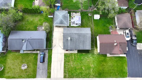 an aerial view of a house with a garden and a yard