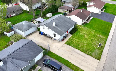 an aerial view of a house with garden space and street view