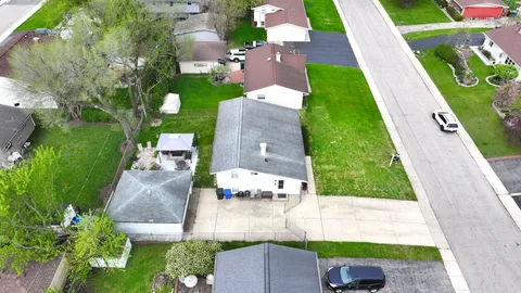 an aerial view of a house with a garden and swimming pool