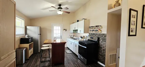 a kitchen with a sink stainless steel appliances and cabinets
