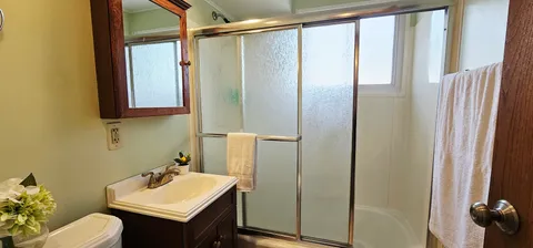 a bathroom with a sink toilet and shower