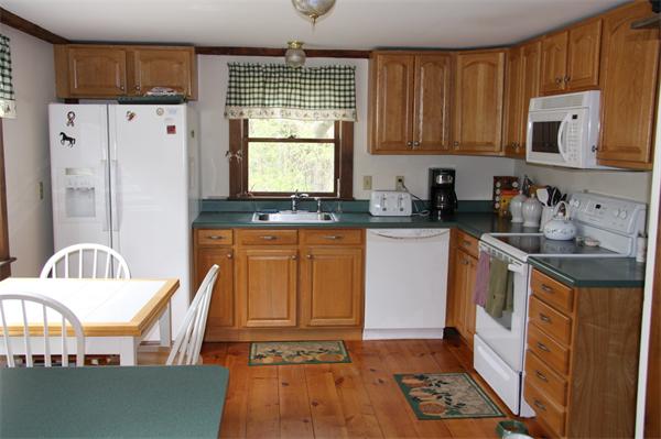 289 Hurricane Hill Road Mason, NH 03048 - Photo 11 of 30 a kitchen with granite countertop a stove a sink dishwasher and a refrigerator