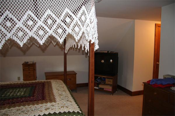 289 Hurricane Hill Road Mason, NH 03048 - Photo 23 of 30 a bedroom with a bed and a table