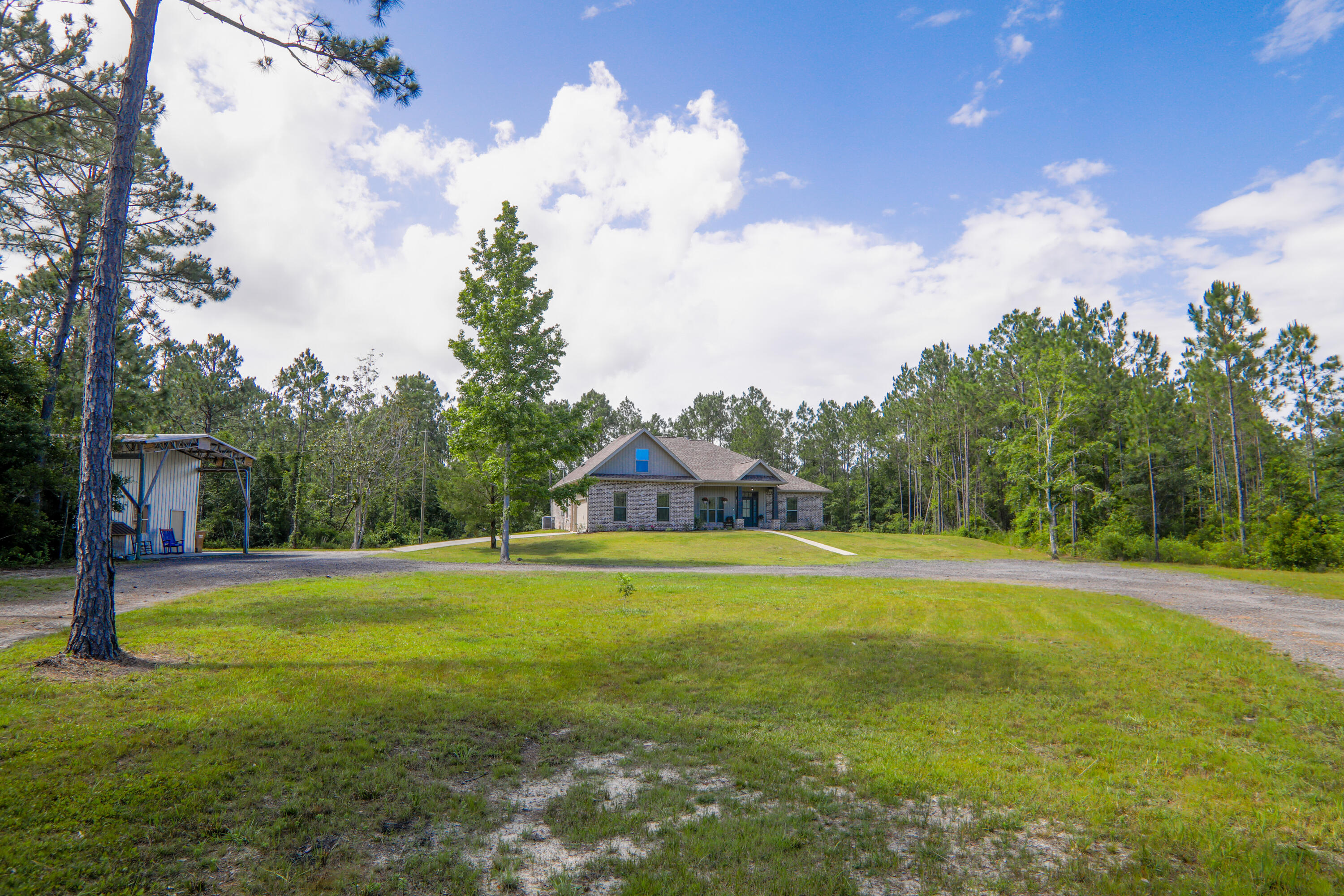 3037 Robinson Point Road Milton, FL 32583 - Photo 1 of 22 a big yard with lots of green space and plants