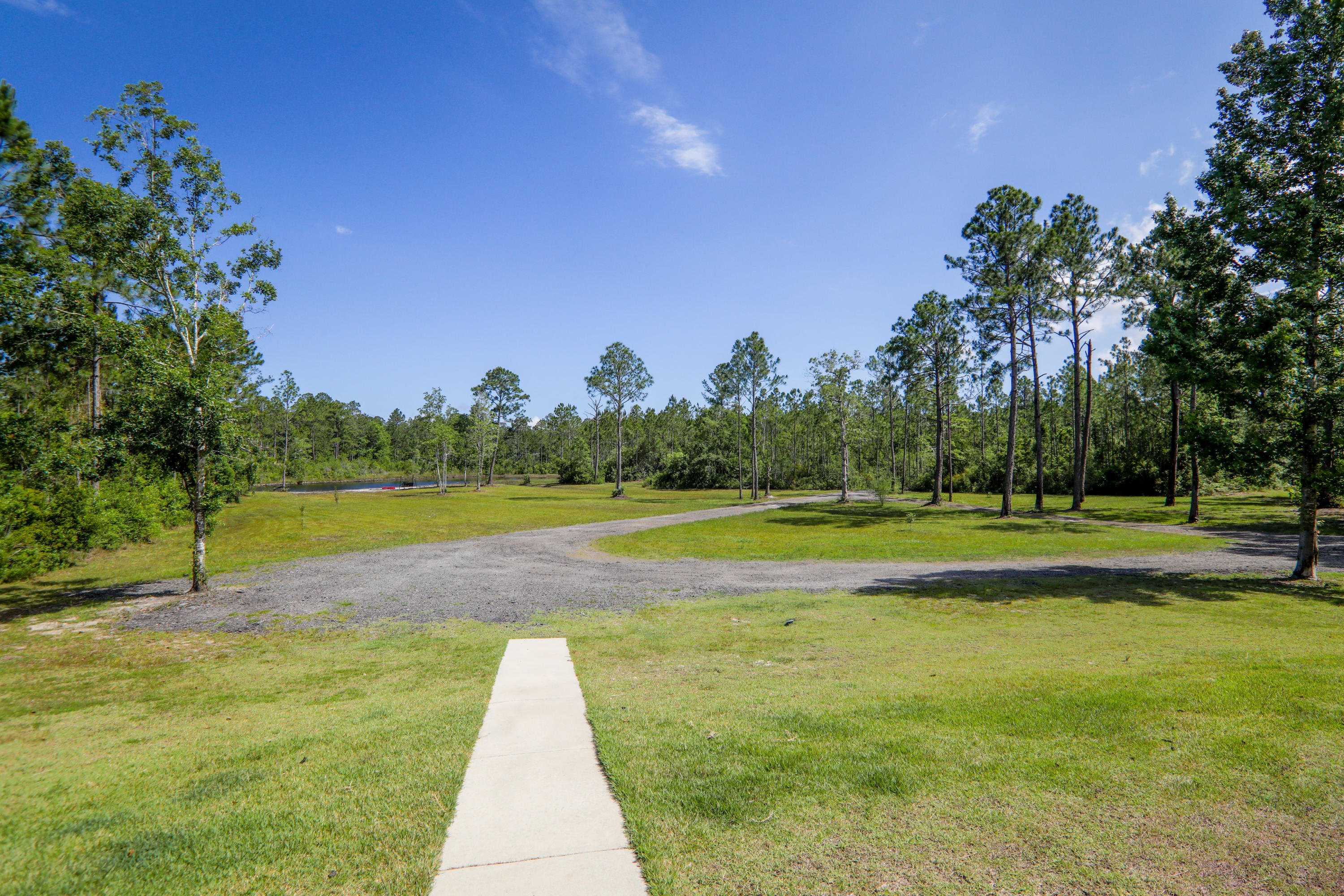 3037 Robinson Point Road Milton, FL 32583 - Photo 21 of 22 a view of a swimming pool with a yard