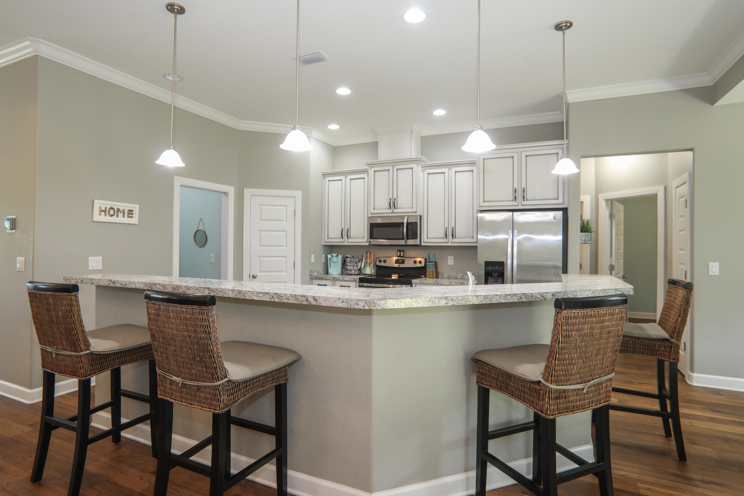 3037 Robinson Point Road Milton, FL 32583 - Photo 7 of 22 a kitchen with a table chairs refrigerator and microwave