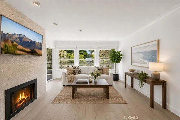 a living room with furniture a fireplace and a flat screen tv