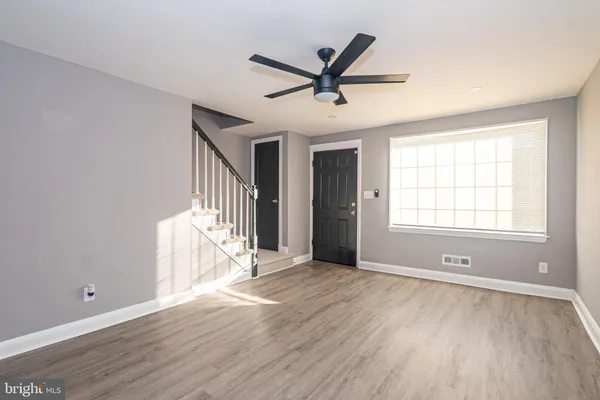 a view of a livingroom with a ceiling fan and window