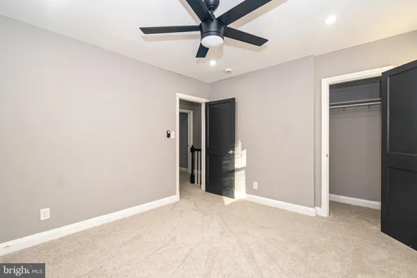 a view of an empty room with a ceiling fan