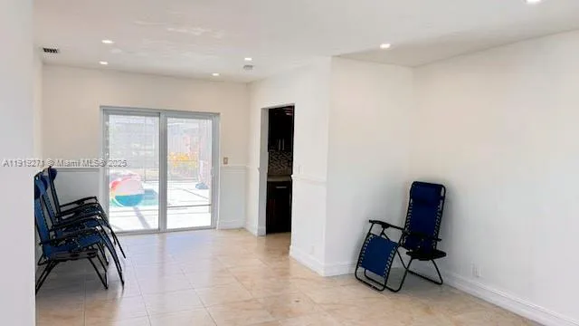 a living room with furniture a rug and a large window