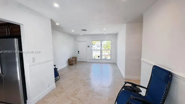 a view of an empty room and a window