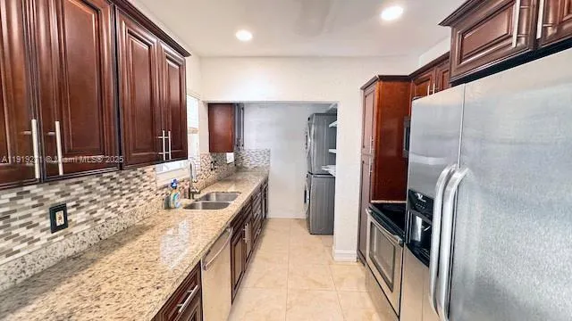 a bathroom with a granite countertop sink and a large mirror
