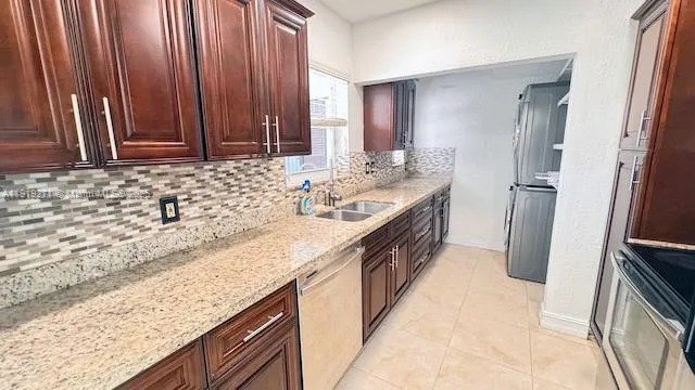 a kitchen with stainless steel appliances granite countertop a stove and a refrigerator