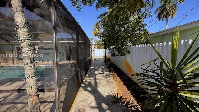 a view of backyard with wheel chair potted plants and large tree