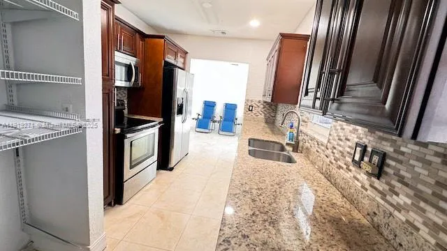 a kitchen with a sink and a large window