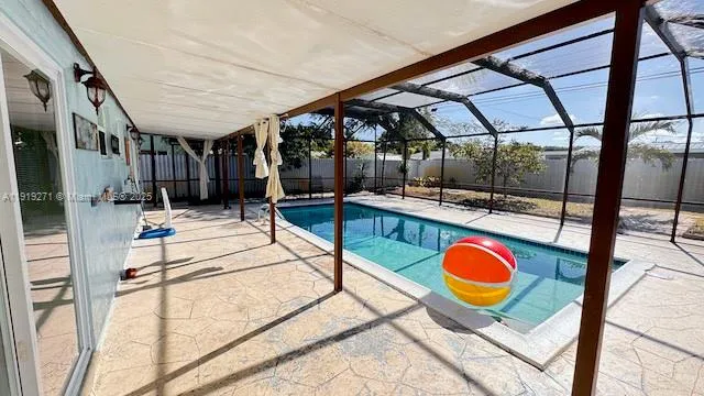 a view of an empty room with wooden floor and iron stairs
