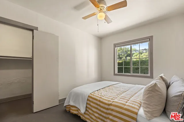 a bedroom with a bed and a window