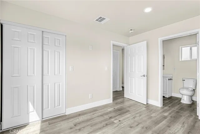 a view of a room with wooden floor and bathroom view