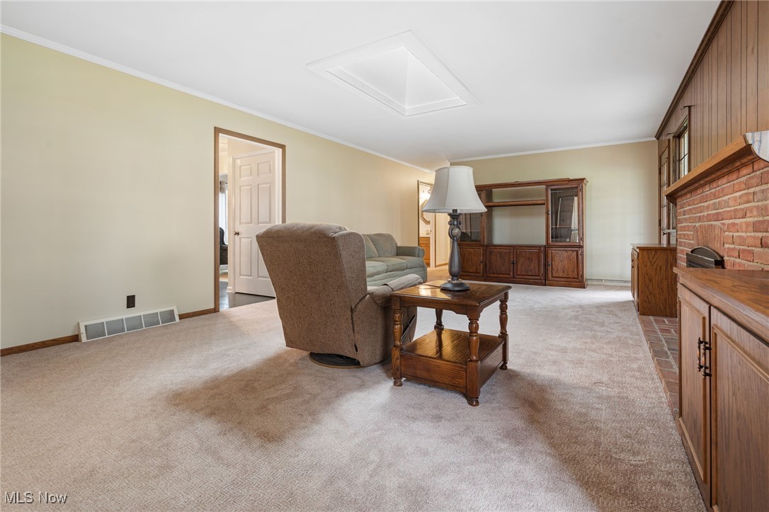 14265 Reeder Avenue Northeast Alliance, OH 44601 - Photo 9 of 39 Living room with crown molding, attic access, and light carpet