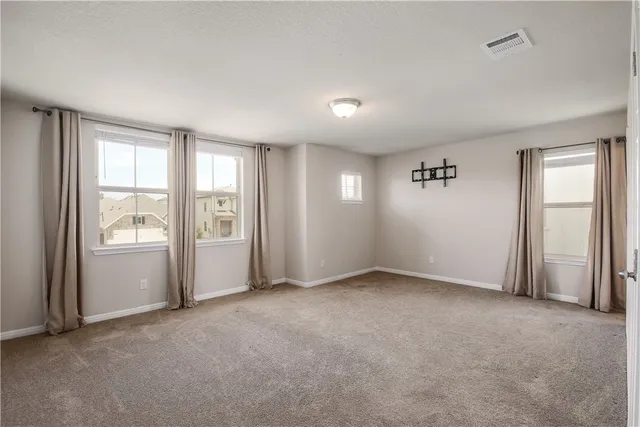 an empty room with windows and closet