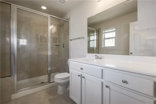 a bathroom with a double vanity sink toilet and shower