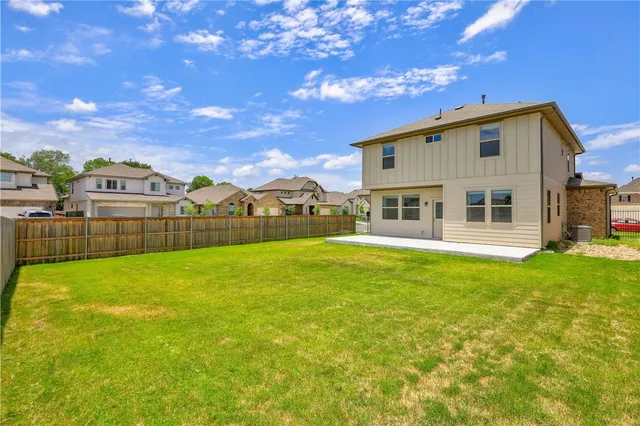 a view of a house with backyard and garden